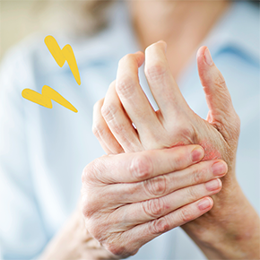 Person holding their hand feeling joint pain