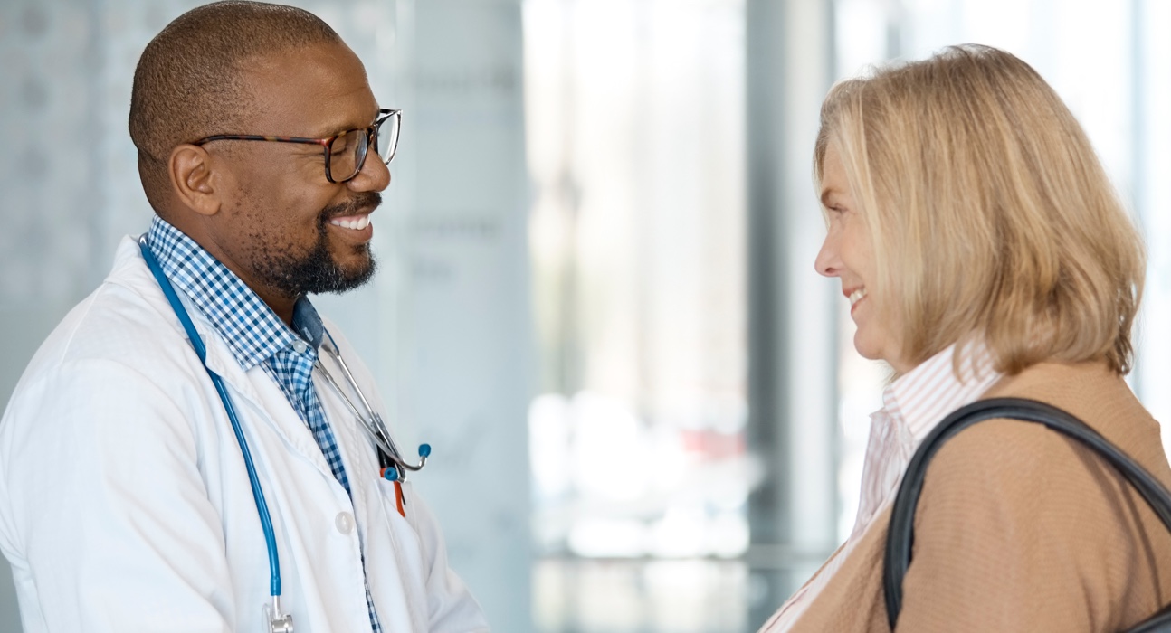 Photo of psoriasis patient and dermatologist engaged in conversation